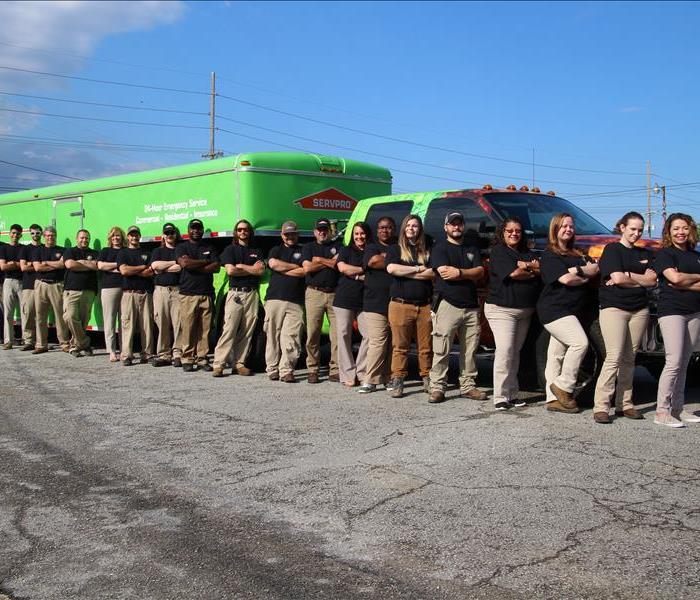 This is a photo of our entire staff. Each person is wearing a black shirt and tan pants